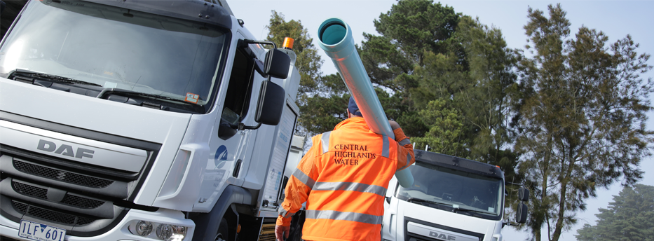 Staff member holding pipe